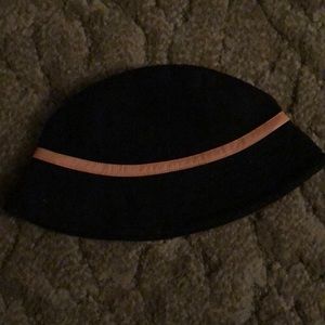 Black bucket hat with tan leather trim